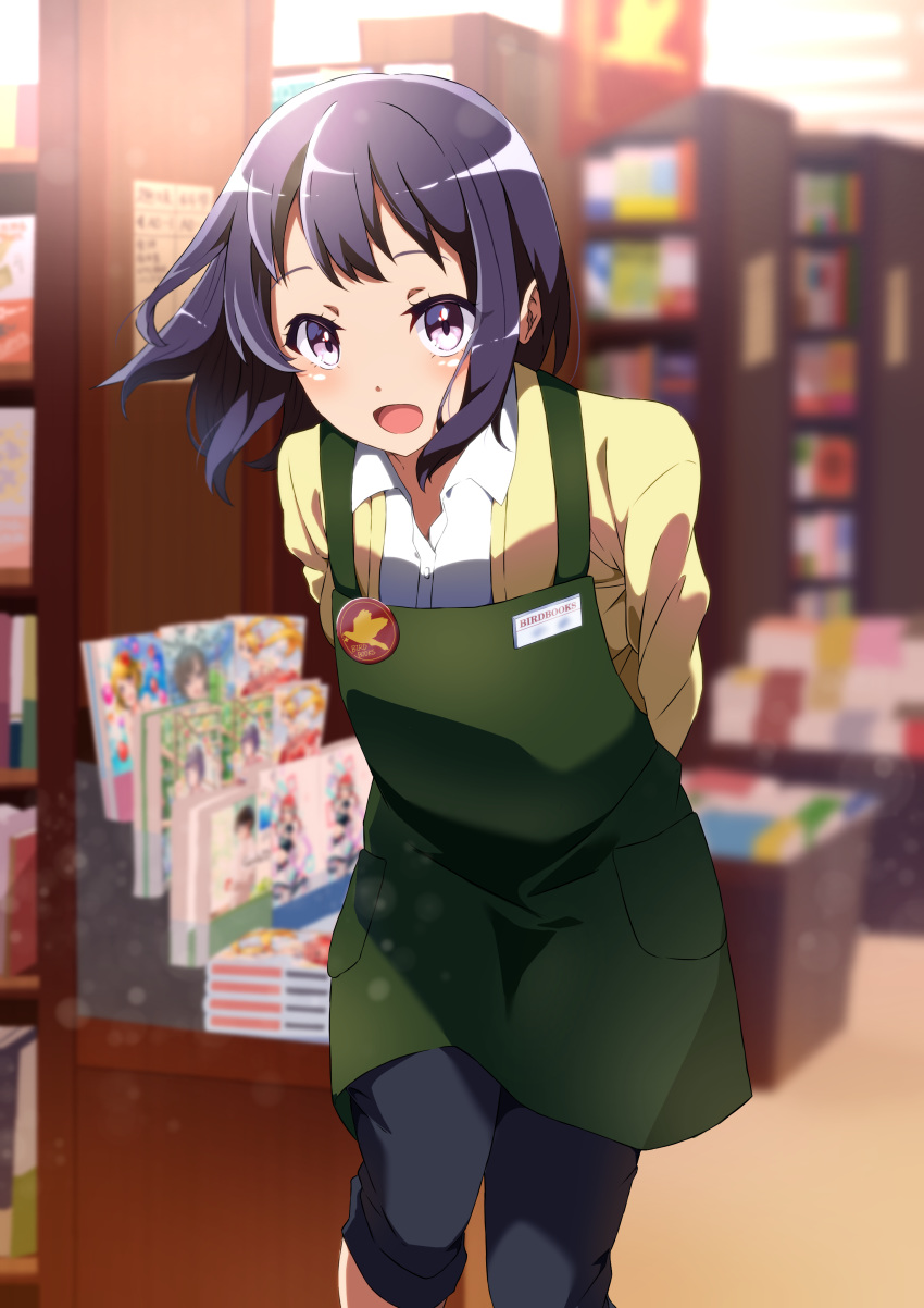 :d absurdres apron badge black_hair blush bookshelf bookstore buttons collared_shirt commentary_request employee_uniform eyelashes female green_apron highres indoors leaning_forward looking_at_viewer medium_hair open_mouth original pink_eyes pon_yui shirt shop smile solo standing tongue uniform white_shirt