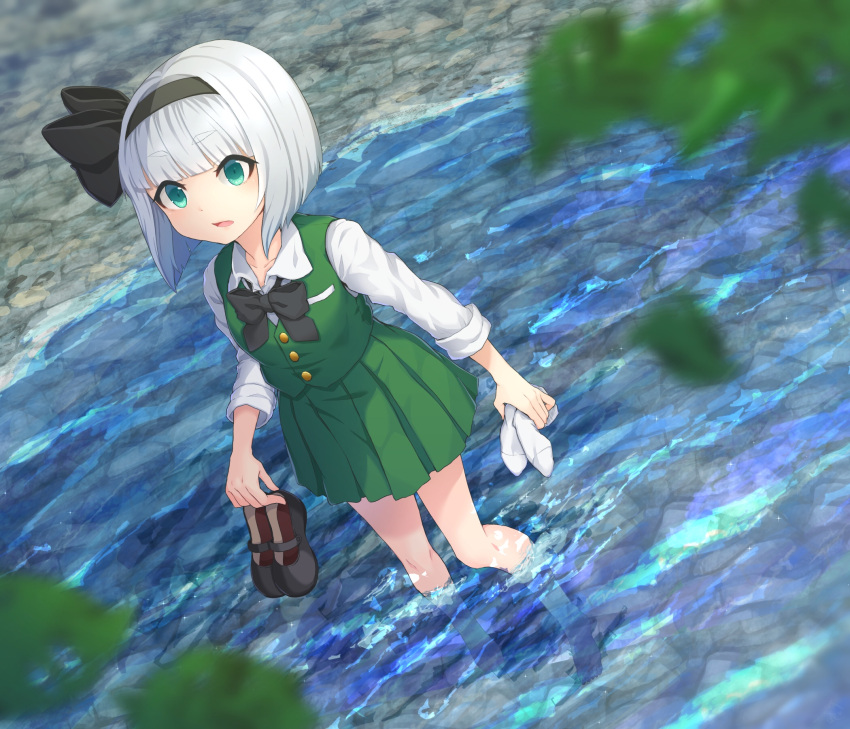 barefoot black_bow black_bowtie black_hairband blunt_bangs blurry blurry_foreground bob_cut bow bowtie buttons collared_shirt commentary dutch_angle female full_body green_eyes green_skirt green_vest grey_hair hairband highres holding holding_clothes holding_footwear holding_legwear konpaku_youmu kuroneko13x long_sleeves open_mouth outdoors partially_submerged plant pleated_skirt shirt shoes short_hair skirt solo standing touhou unworn_legwear unworn_shoes vest white_shirt