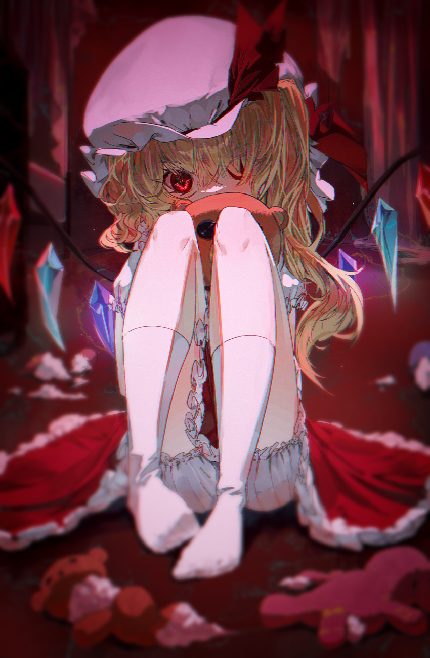 absurdres blonde_hair bloomers commentary crystal dress female flandre_scarlet full_body hat hat_ribbon highres knees_up long_hair looking_at_viewer mob_cap mont_blanca red_dress red_eyes red_ribbon ribbon socks solo stuffed_animal stuffed_toy teddy_bear touhou underwear white_hat white_socks wings