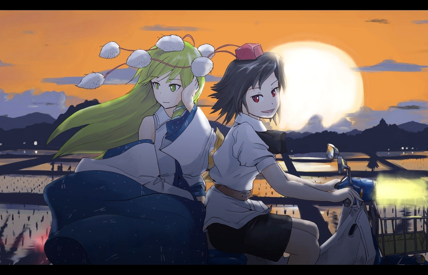 2girls black_hair buncha_to_imon commentary_request detached_sleeves green_eyes green_hair hat kochiya_sanae letterboxed long_hair motor_vehicle multiple_girls on_scooter pom_pom_(clothes) red_eyes rice_paddy scooter shameimaru_aya short_hair sunset tokin_hat touhou