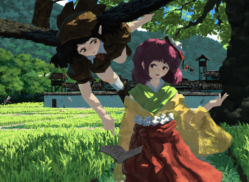 2girls black_hair brown_headwear commentary_request flower forbidden_scrollery hair_flower hair_ornament hat hieda_no_akyuu highres japanese_clothes kajatony kimono multiple_girls official_alternate_costume open_mouth outdoors purple_hair rice_paddy shameimaru_aya shameimaru_aya_(newsboy) sky touhou tree village wall wings