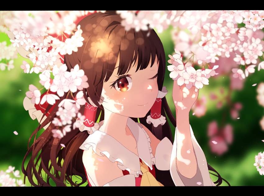 ametama_(runarunaruta5656) anime_coloring arm_up ascot blurry blurry_background blush bow brown_eyes brown_hair cherry_blossoms commentary dappled_sunlight depth_of_field detached_sleeves female flower hair_tubes hairbow hakurei_reimu highres holding holding_flower letterboxed long_hair looking_at_viewer one_eye_closed petals ponytail red_vest smile solo standing sunlight touhou upper_body vest yellow_ascot