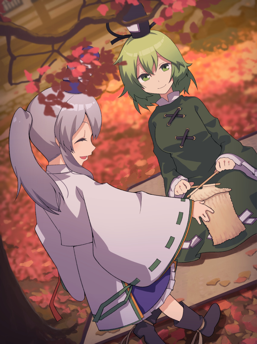 2girls autumn_leaves boots closed_eyes commentary_request dress frilled_skirt frills green_dress green_eyes green_hair grey_hair hat highres japanese_clothes kariginu knitting knitting_needle leaf light_smile mononobe_no_futo multiple_girls needle nurupo_(abooon) open_mouth ponytail ribbon-trimmed_sleeves ribbon_trim short_hair sidelocks skirt soga_no_tojiko standing tate_eboshi touhou tree wide_sleeves