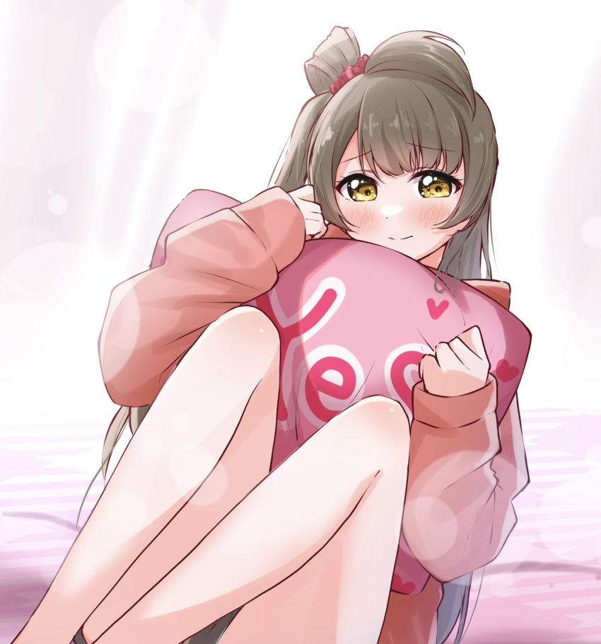 bare_legs blush brown_hair brown_shorts closed_mouth female hands_up highres hood hoodie kiryu_(sora_no_iroto) knees_up long_sleeves looking_at_viewer love_live! love_live!_school_idol_project minami_kotori one_side_up pink_hoodie short_shorts shorts single_hair_ring sitting sleeves_past_wrists smile solo split_mouth yellow_eyes yes-no_pillow