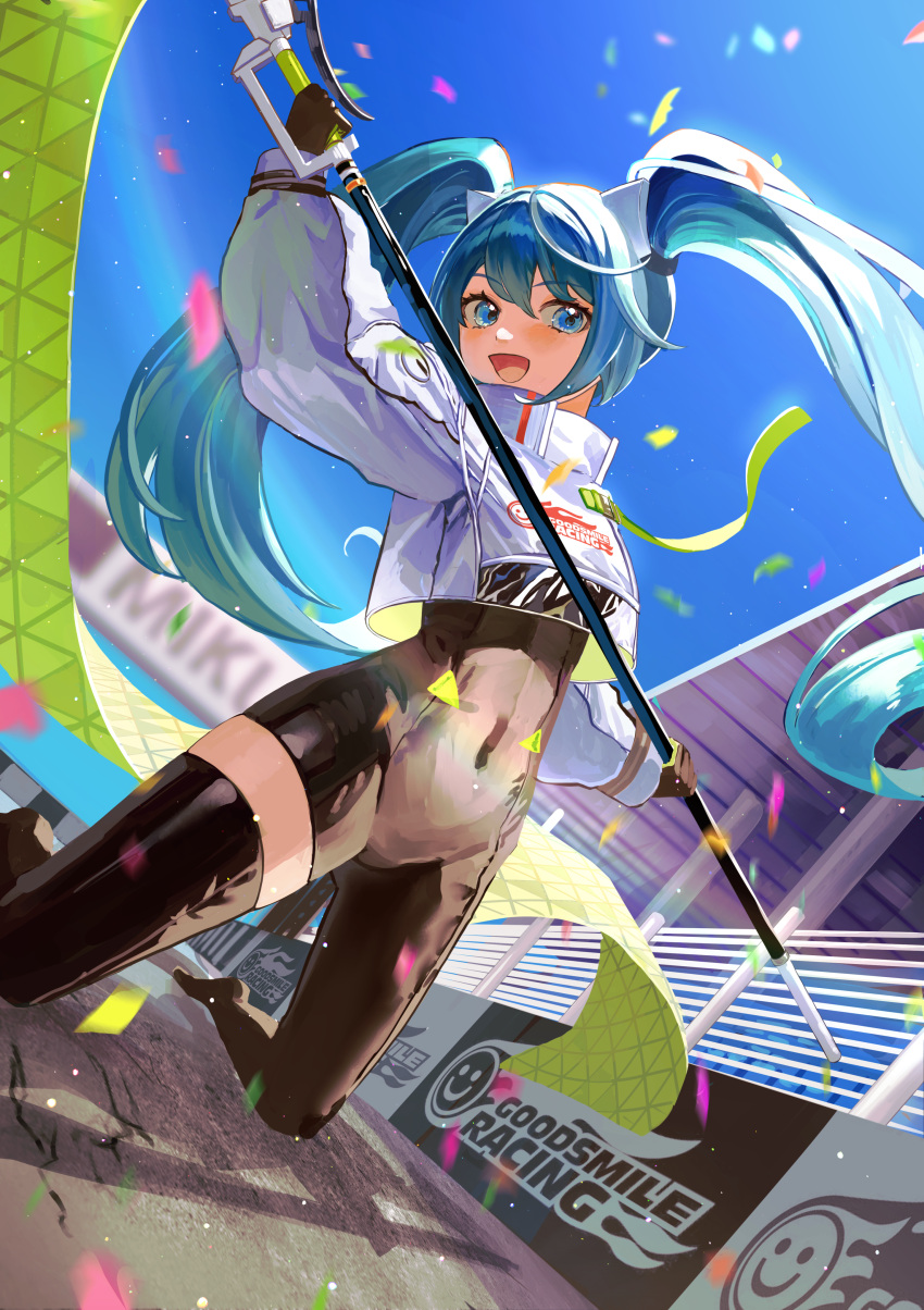 :d absurdres arm_up asymmetrical_bodysuit blue_hair blush bodysuit character_name commentary confetti covered_navel cropped_jacket day female finish_line flag gloves goodsmile_racing hatsune_miku high_collar highres holding holding_flag kneeling long_hair long_sleeves nemari_(user_wtca7244) on_ground open_mouth outdoors pavement racing_miku racing_miku_(2022) single_thighhigh sky smile solo thighhighs twintails very_long_hair vocaloid wind