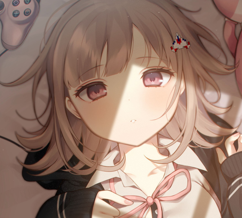 backpack bag bed_sheet black_jacket brown_hair commentary_request danganronpa_(series) danganronpa_2:_goodbye_despair female galaga hair_ornament hands_up highres hood hood_down hooded_jacket jacket looking_at_viewer lying medium_hair nanami_chiaki neck_ribbon on_back parted_lips pink_eyes pink_nails pink_ribbon playstation_controller ribbon shirt sleeves_past_wrists solo spaceship_hair_ornament teeth unworn_backpack unworn_bag upper_body usanta white_shirt