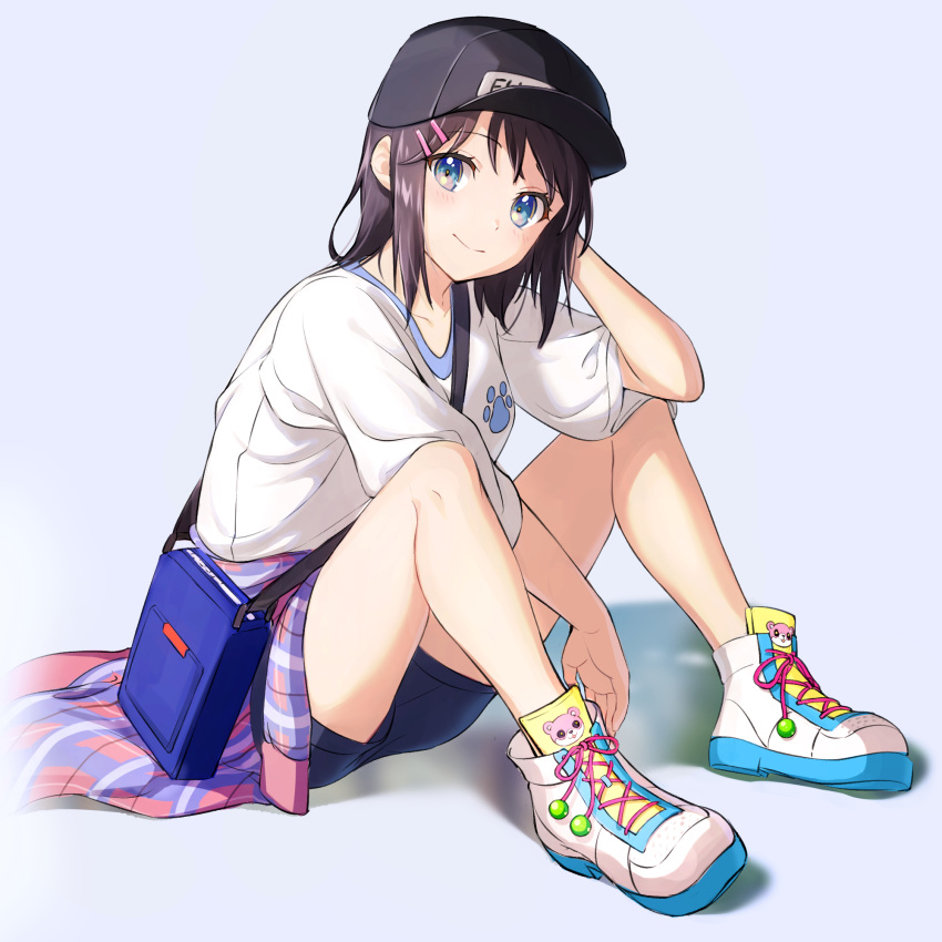 bag bang_dream! bare_legs baseball_cap black_hair black_hat black_shorts blue_background blue_eyes blush closed_mouth clothes_around_waist commentary_request female full_body gen_(gen_m_gen) hair_ornament hairclip hat highres knees_up looking_at_viewer multicolored_footwear okusawa_misaki paw_print shirt short_hair short_sleeves shorts shoulder_bag simple_background sitting smile solo white_shirt