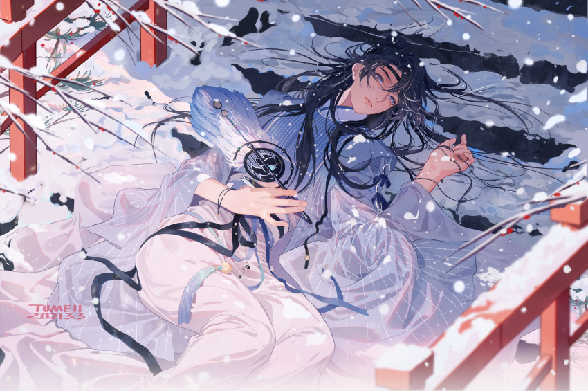 1boy absurdres apricot_flower artist_name black_hair black_headband blue_dress chinese_clothes dress hand_fan hand_in_own_hair headband highres holding holding_fan long_hair long_sleeves looking_at_viewer lying male_focus original pants see-through snow snowflakes snowing stairs transparent tumeii white_pants