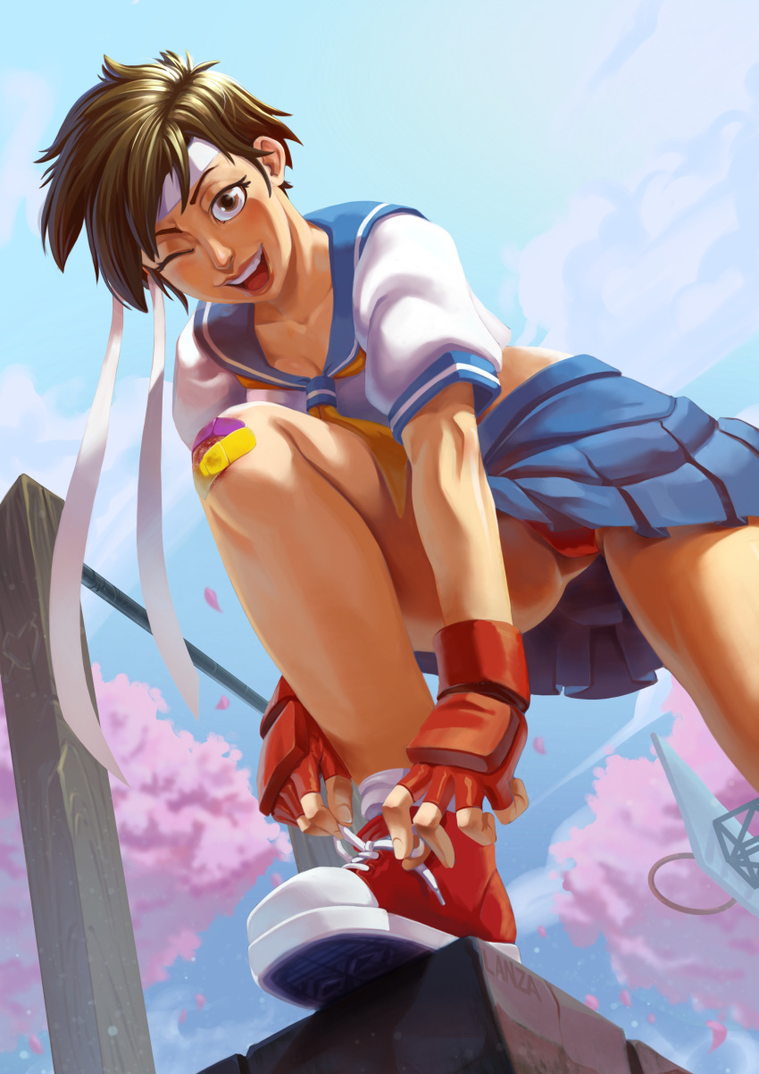 absurdres bandaid bandaid_on_knee bandaid_on_leg blue_serafuku blue_skirt brown_eyes brown_hair bruise_on_knee cherry_blossoms cloud cloudy_sky commentary converse crop_top day english_commentary female fingerless_gloves from_below gloves headband highres kasugano_sakura leg_up looking_at_viewer one_eye_closed open_mouth panties pantyshot red_footwear red_gloves red_panties school_uniform serafuku shoes short_hair sketch_lanza skirt sky smile sneakers socks solo street_fighter street_fighter_zero_(series) teeth tomboy tying_footwear underwear upper_teeth_only upskirt white_headband white_socks