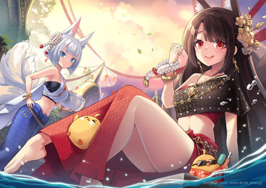 2girls akagi_(azur_lane) alternate_costume animal_ear_fluff animal_ears architecture azur_lane bare_shoulders barefoot commentary english_commentary fox_ears fox_girl fox_tail hair_ornament highres hm_(hmongt) holding jewelry kaga_(azur_lane) looking_at_viewer manjuu_(azur_lane) midriff multiple_girls navel necklace pagoda single_bare_shoulder smile songkran stomach sunglasses tail thai_clothes thailand thighs traditional_clothes water