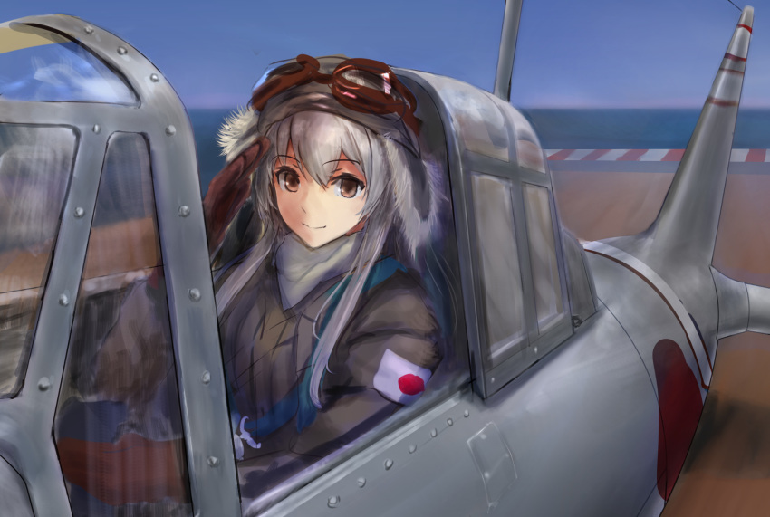 a6m_zero aircraft airplane alternate_costume aviator_cap brown_eyes brown_gloves day female fur gloves goggles goggles_on_headwear hair_between_eyes haruto_(harut_n) hat highres jacket japanese_flag kantai_collection long_hair long_sleeves ocean outdoors salute shoukaku_(kancolle) sidelocks sky smile solo white_hair