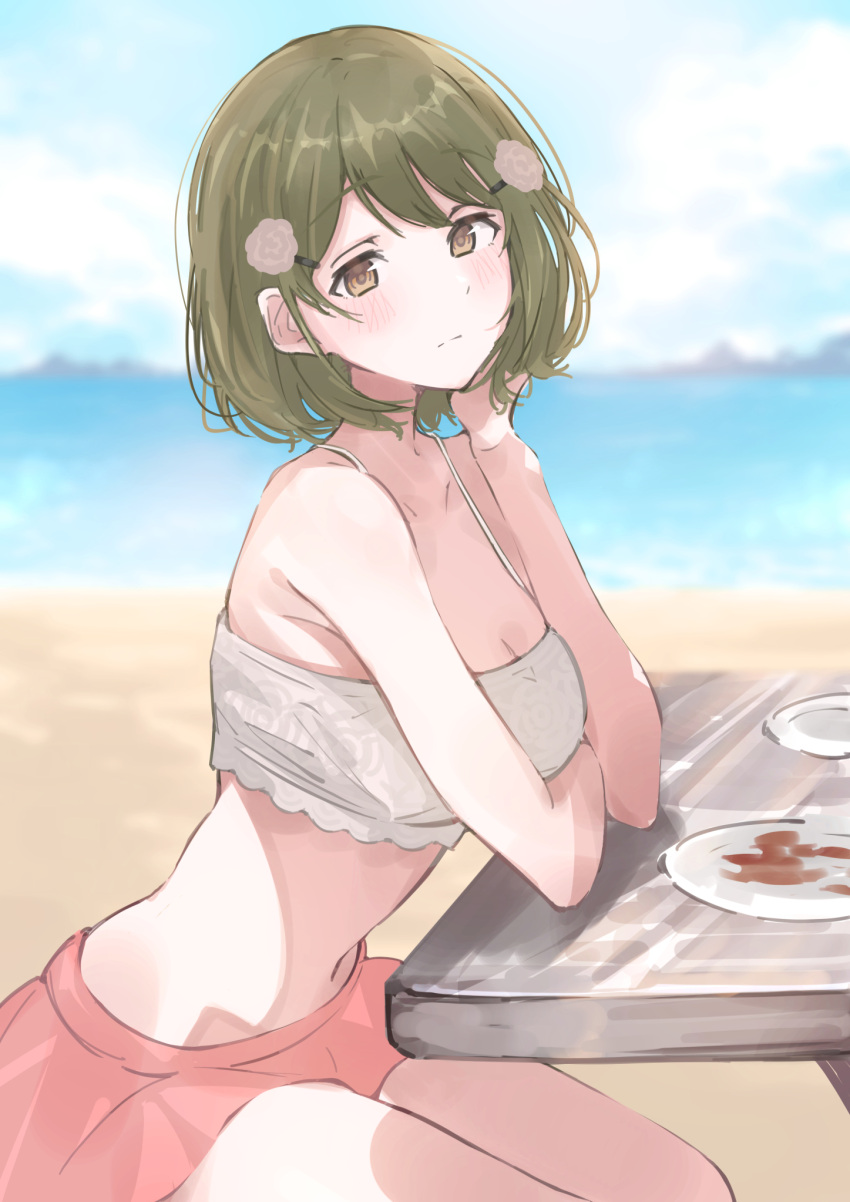 beach bikini bikini_top_only blurry blurry_background blush breasts cleavage collarbone commentary female green_eyes green_hair highres idolmaster idolmaster_shiny_colors looking_at_viewer looking_to_the_side medium_breasts nanakusa_nichika natsumegu_(yvku8527) navel outdoors pink_skirt short_hair sitting skirt solo stomach swimsuit thighs white_bikini