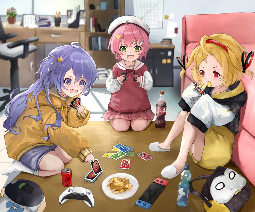 3girls adapted_costume aged_down ahoge alternate_costume beret black_hoodie blonde_hair blurry blurry_background blush card card_game ckia_(kaela_kovalskia) cola controller couch drink food game_controller green_eyes hair_ornament hairband hat highres holding holding_card hololive hololive_indonesia hood hoodie indoors kaela_kovalskia kneeling knees_up long_hair long_sleeves moona_hoshinova multiple_girls nintendo_switch official_alternate_costume open_mouth pink_hair pinnfyn plate purple_eyes purple_hair purple_shorts red_eyes sakura_miko sakura_miko_(school_uniform) short_hair shorts sitting sleeves_past_fingers sleeves_past_wrists slippers socks star_(symbol) star_hair_ornament uno_(game) virtual_youtuber wavy_mouth white_footwear white_hat white_socks yellow_hoodie yellow_shorts