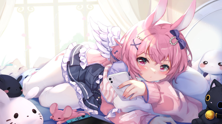 animal_ears bed bow cellphone commentary curtains doll english_commentary female hair_between_eyes hair_ornament highres indie_virtual_youtuber iphone_11_pro long_sleeves nintendo_switch nyatrix pantyhose phone pink_eyes pink_hair rabbit_ears short_hair smartphone usagi_kira virtual_youtuber wings