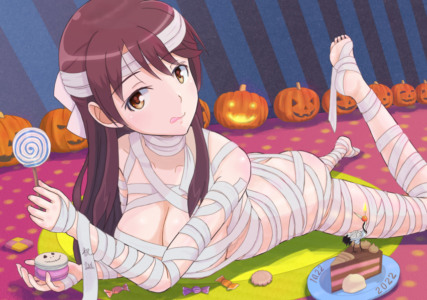 ass bandages blush brave_witches breasts brown_eyes brown_hair butt_crack cake candy cleavage closed_mouth collarbone cookie female food halloween jack-o'-lantern karibuchi_takami keicha_(kmoekaki) large_breasts lollipop long_hair lying mummy_costume on_stomach shiny_skin solo tongue tongue_out world_witches_series