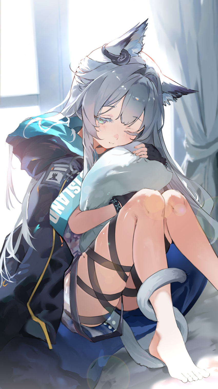 animal_ears arknights backlighting barefoot black_gloves blush cat_ears cat_girl cat_tail closed_mouth commentary curtains english_commentary female foot_out_of_frame gloves green_eyes grey_hair highres hood hood_down hooded_jacket hug hugging_object indoors jacket one_eye_closed parted_bangs pillow pillow_hug rosmontis_(arknights) sitting solo sunlight tail umou_(umouawa)