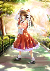  absurdres bow brown_eyes brown_hair bush chinese_commentary commentary_request dappled_sunlight detached_sleeves female fence gohei grass hair_tubes hairbow hakurei_reimu highres long_hair mary_janes nature red_skirt shade shoes skirt stance standing sunlight talisman touhou tree vest xiaoyin_li 