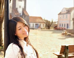  bench black_hair building chihara_minori closed_eyes dark_hair highres house leaning long_hair outdoors photo seiyuu smile teeth tree white_clothes window 