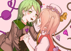  2girls alternate_hairstyle bad_id bad_pixiv_id black_headwear blonde_hair blush braid candy chocolate closed_eyes commentary_request crystal eyeball flandre_scarlet food green_eyes green_hair hat heart heart-shaped_chocolate heart-shaped_pupils holding_hands interlocked_fingers komeiji_koishi long_sleeves looking_at_another mob_cap mouth_hold multiple_girls one_side_up pink_background pointy_ears simple_background soku_(bluerule-graypray) symbol-shaped_pupils third_eye touhou valentine white_headwear wings yuri 