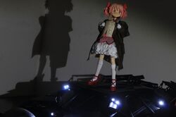  bane bane_(cosplay) batman_(series) batmobile coat cosplay crossover dc_comics female figure fur_trim jacket kaname_madoka kaname_madoka_(magical_girl) mahou_shoujo_madoka_magica mahou_shoujo_madoka_magica_(anime) moonshine_animations parody photo_(medium) pink_eyes pink_hair ribbon self-upload solo the_dark_knight_rises 