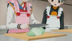  1boy animated animated anime_screenshot apron brown_eyes cabbage cooking cutting cutting_board emelenzia_beatrix_rudiger female flat_chest food frilled_apron frills green_hair head_out_of_frame heart heart_print holding indoors kitchen knife long_sleeves mamoru-kun_ni_megami_no_shukufuku_wo! necktie open_mouth school_uniform skirt standing turtleneck upper_body yoshimura_mamoru 