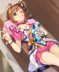  ahoge bottle brown_hair butterfly_hair_ornament butterfly_ornament choker commentary couch drill_hair female grin hair_ornament hair_ribbon holding holding_bottle idol idolmaster idolmaster_million_live! idolmaster_million_live!_theater_days jacket kamille_(vcx68) looking_at_viewer lying medium_hair nouvelle_tricolor_(idolmaster) on_back on_couch one_eye_closed pillow pink_choker pink_shorts polka_dot polka_dot_shorts purple_eyes ribbon sash short_shorts short_sleeves shorts side_drill sidelocks smile solo sweat v water_bottle white_jacket white_ribbon wrist_cuffs yokoyama_nao 