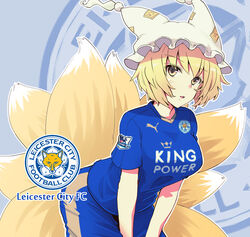  blonde_hair clothes_writing commentary_request england english_text female fox_tail fujii_jun hat jersey leicester_city_fc looking_at_viewer multiple_tails photoshop_(medium) premier_league puma_(brand) short_hair soccer soccer_uniform solo sportswear tail touhou trait_connection yakumo_ran yellow_eyes 