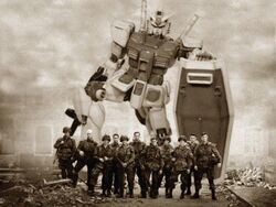  506th_parachute_infantry_regiment_(us_army) 6+boys army band_of_brothers beam_rifle city energy_gun gun gundam long_sleeves mecha military military_uniform mobile_suit_gundam monochrome multiple_boys parody photo_(medium) robot ruins rx-78-2 sepia shield soldier source_request third-party_edit uniform weapon world_war_ii 