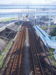  absurdres bridge brown_hair building commentary_request day dress female floating grass highres lamppost long_hair moribuden original outdoors photorealistic railroad_tracks realistic road scenery sky solo white_dress white_sky wide_shot 