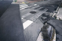  city commentary_request day drain_(object) grass manhole_cover moribuden no_humans original outdoors photorealistic puddle realistic road scenery street tactile_paving water 