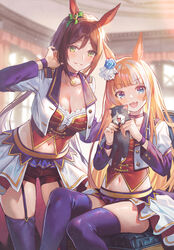  2girls :d akikawa_yayoi_(umamusume) animal animal_ears blonde_hair blue_eyes blue_flower blue_rose blue_thighhighs blurry blurry_background blush bow breasts brown_hair cleavage collarbone commentary_request cropped_jacket feline flower garter_straps green_eyes hair_flower hair_ornament hairbow hayakawa_tazuna highres holding holding_animal holding_cat horse_ears horse_girl horseshoe_ornament indoors large_breasts lino_chang long_hair long_sleeves looking_at_viewer multicolored_hair multiple_girls navel oerba_yun_fang open_mouth overskirt rose shorts sitting skin_fang skindentation smile starting_future_(umamusume) stomach streaked_hair thighhighs tucking_hair umamusume white_hair wristband 