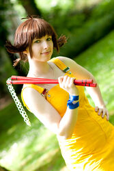  cosplay dress female final_fantasy final_fantasy_viii highres nunchaku photo selphie_tilmitt selphie_tilmitt_(cosplay) smile solo weapon yellow_dress 