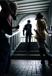  2boys boots cosplay dress female final_fantasy final_fantasy_viii gloves gunblade multiple_boys nunchaku pants selphie_tilmitt selphie_tilmitt_(cosplay) squall_leonhart squall_leonhart_(cosplay) stairs weapon yellow_dress zell_dincht zell_dincht_(cosplay) 