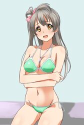  between_breasts bikini bow breasts brown_eyes cleavage commentary_request female green_bikini grey_hair hairbow halterneck highres jewelry long_hair looking_at_viewer love_live! love_live!_school_idol_project medium_breasts minami_kotori navel open_mouth pendant side-tie_bikini_bottom sitting solo strap_gap string_bikini swimsuit turkey_min yellow_eyes 