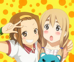  2girls blonde_hair blue_eyes braid brown_eyes brown_hair casual commentary_request grin k-on! kotobuki_tsumugi long_hair multiple_girls samuraichamp smile stuffed_animal stuffed_toy tainaka_ritsu teddy_bear twin_braids 