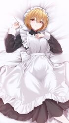  absurdres apron bed_sheet black_dress blonde_hair blush bocchi_(kuropom7) breasts closed_mouth dress female frilled_apron frills hair_between_eyes hands_up highres holding long_sleeves looking_at_viewer lying maid maid_apron maid_headdress medium_breasts mimikaki mole mole_under_eye on_back on_bed original red_eyes short_hair smile solo white_apron 