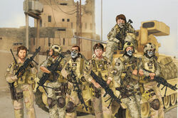  brown_hair facial_hair gloves gun headset helmet highres holster humi_(jun-shu) iraq load_bearing_vest m2_bradley m60 machine_gun military military_vehicle multiple_boys sitting soldier sunglasses vehicle weapon 