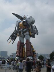  arms_at_sides blurry cannon cloud cloudy_sky commentary_request depth_of_field gundam gundam_msv kou_(mechalog) looking_at_viewer mecha no_humans outdoors perfect_gundam plamo_kyoshiro reactive_armor realistic robot size_difference sky solo standing taking_picture yellow_eyes 