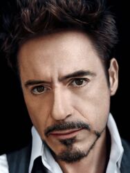  1boy black_hair black_vest brown_hair closed_mouth collared_shirt commentary_request facial_hair goatee highres looking_at_viewer making-of_available male_focus moustache partial_commentary photorealistic photoshop_(medium) portrait real_life realistic robert_downey_jr. shirt short_hair simple_background solo vest white_shirt yakkunn 