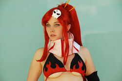  bikini_top breasts cosplay earrings elbow_gloves ellarcy gloves green_eyes jewelry large_breasts nose_piercing nose_stud photo piercing ponytail red_hair skull solo stud_earrings tengen_toppa_gurren_lagann underboob wig yoko_littner 