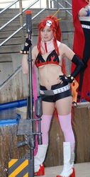  belt bikini_top boots cosplay elbow_gloves ellarcy female fingerless_gloves gloves gun hand_on_hip kamina long_hair photo ponytail red_hair short_shorts shorts skull studded_belt tengen_toppa_gurren_lagann thighhighs weapon yoko_littner 