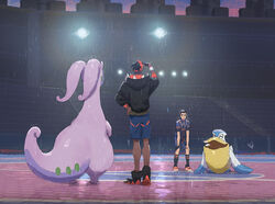  2boys black_hair black_hoodie blue_shorts commentary_request dark-skinned_male dark_skin dynamax_band gloves goodra gym_trainer_(pokemon) hood hoodie leaning_forward light male_focus multiple_boys orange_headwear partially_fingerless_gloves pelipper pokemon pokemon_(creature) pokemon_swsh raihan_(pokemon) rain reflection shirt shoes short_sleeves shorts single_glove stadium standing zukki_(suzukio) 