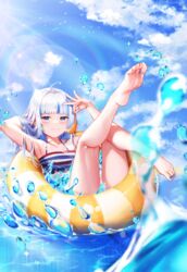  ahoge arm_up armpits barefoot bikini blue_eyes blue_nails blue_sky blunt_bangs blurry blurry_foreground blush closed_mouth cloud cloudy_sky collarbone commentary day ebi-chan_(gawr_gura) english_commentary feet female fins fish_tail flat_chest frills gawr_gura grey_hair hand_up highres holding hololive hololive_english innertube knee_up koukie leg_up legs lens_flare long_hair looking_at_viewer multicolored_hair nail_polish official_alternate_costume outdoors shark_girl shark_tail shiny_skin shrimp sky smile soles solo streaked_hair striped_bikini striped_clothes swim_ring swimsuit tail toenail_polish toenails toes virtual_youtuber water 