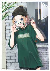  absurdres black_headwear blonde_hair blue_eyes cellphone cellphone_photo earrings female green_shirt hat_ornament highres holding holding_phone hoop_earrings jewelry knit_hat ko_tachi1104 nail_polish oerba_yun_fang original phone red_nails shirt short_hair shorts skin_fang smartphone standing 