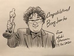  1boy academy_award_of_merit artist_name bong_joon-ho bow bowtie congratulations curly_hair dated english_text glasses grin highres male_focus parasite_(film) real_life smile statue urasawa_naoki 