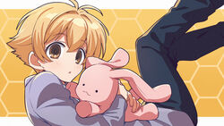  1boy antenna_hair asada_hachi bangs banned_artist black_pants blazer blonde_hair blush commentary eyebrows_visible_through_hair from_side haninozuka_mitsukuni highres holding holding_stuffed_toy honeycomb_(pattern) honeycomb_background jacket legs_up long_sleeves looking_at_viewer male_focus object_hug ouran_high_school_host_club ouran_high_school_uniform pants parted_lips purple_jacket school_uniform short_hair solo stuffed_animal stuffed_bunny stuffed_toy twitter_username watermark yellow_eyes 