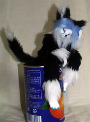 anthro biped black_body black_fur black_nose blue_claws blue_hair bureido claws domestic_cat felid feline felis female fluffy fur grandfathered_content hair long_hair mammal multicolored_body multicolored_fur multicolored_hair paws real sculpture_(artwork) simple_background sitting solo tail traditional_media_(artwork) two_tone_body two_tone_fur two_tone_hair white_body white_fur white_hair