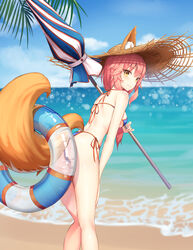  absurdres animal_ear_fluff animal_ears ass beach beach_umbrella bikini blue_bikini blush breasts commentary day fate/grand_order fate_(series) female fox_ears fox_girl fox_tail from_behind halterneck hat herol highres innertube leaning_forward looking_at_viewer looking_back medium_breasts ocean outdoors palm_leaf palm_tree parasol pink_hair side-tie_bikini_bottom solo straw_hat string_bikini summer sun_hat swim_ring swimsuit tail tamamo_(fate) tamamo_no_mae_(swimsuit_lancer)_(fate) tree umbrella yellow_eyes 