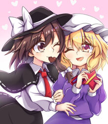  2girls :d arm_hug arms_up black_capelet black_headwear black_skirt blonde_hair breasts brown_eyes brown_hair candy capelet chocolate commentary_request cowboy_shot dress dress_shirt food hair_between_eyes hat hat_ribbon heart heart-shaped_chocolate heart_background highres juliet_sleeves keyaki_chimaki long_sleeves looking_at_another maribel_hearn medium_breasts mob_cap mouth_hold multiple_girls neck_ribbon necktie one_eye_closed open_mouth pink_background puffy_sleeves purple_dress purple_eyes red_necktie red_ribbon ribbon ribbon-trimmed_capelet ribbon-trimmed_skirt ribbon_trim shared_food shirt short_hair single_sidelock skirt smile standing star-shaped_box touhou usami_renko valentine white_headwear white_shirt yuri 