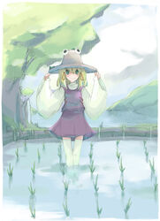  blonde_hair cloud day dress female green_eyes hair_ribbon hat moriya_suwako ribbon rice_paddy short_hair sky smile solo takanashi_akihito thighhighs touhou tree wading water 